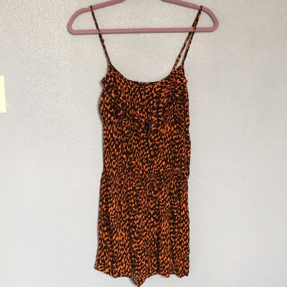 orange and black ruffled romper